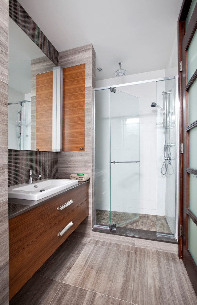 Photo of a medium sized contemporary ensuite bathroom in Other with flat-panel cabinets, medium wood cabinets, a japanese bath, an alcove shower, a one-piece toilet, white walls, porcelain flooring, a built-in sink, grey floors and a hinged door.