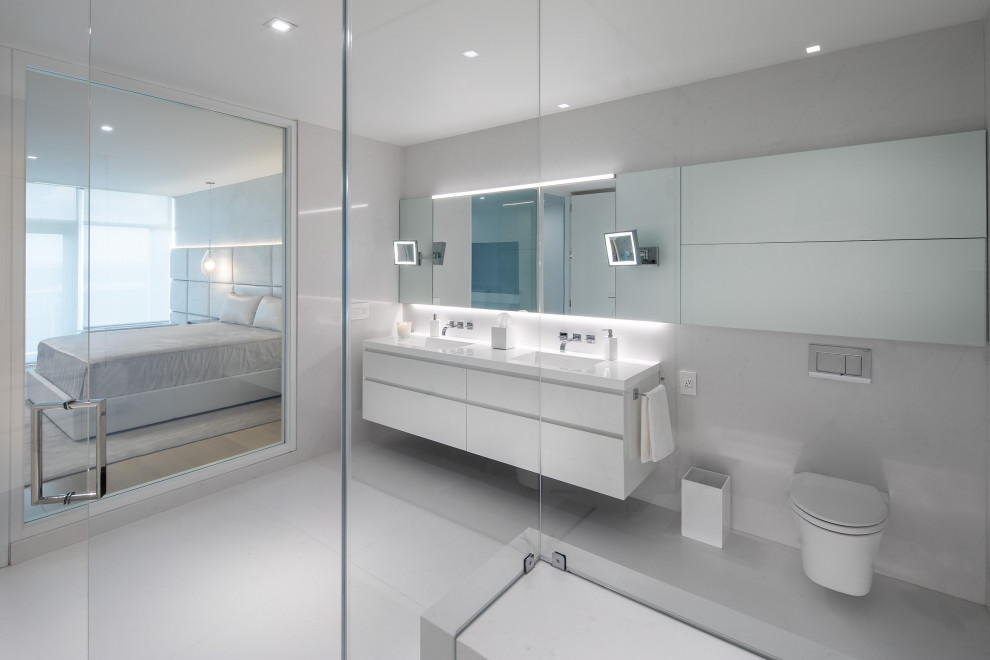 Design ideas for a contemporary ensuite bathroom in Philadelphia with flat-panel cabinets, white cabinets, white tiles, double sinks and a floating vanity unit.