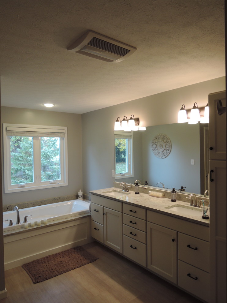 Example of a mid-sized classic master white tile and ceramic tile ceramic tile bathroom design in Indianapolis with a vessel sink, raised-panel cabinets, beige cabinets, marble countertops, a two-piece toilet and gray walls