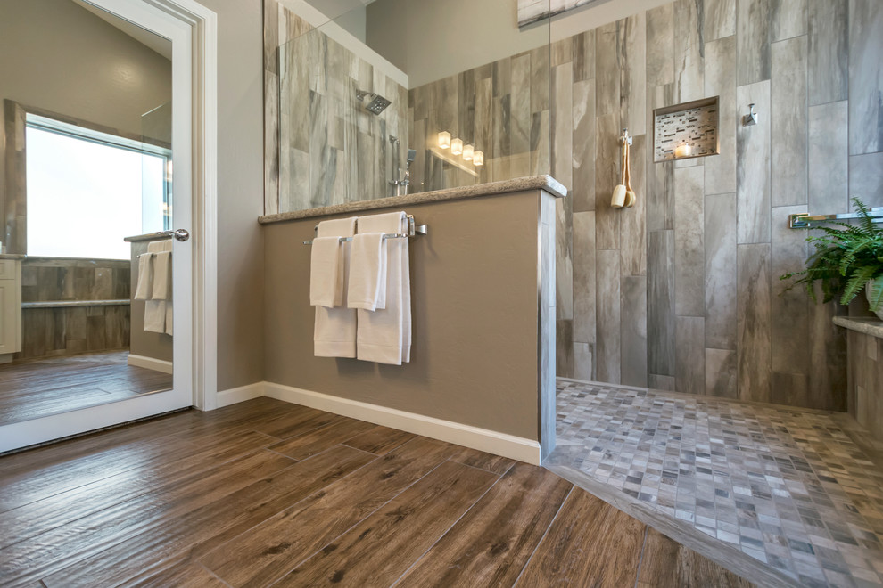 Inspiration for a medium sized classic ensuite bathroom in Phoenix with raised-panel cabinets, white cabinets, a built-in shower, grey tiles, porcelain tiles, grey walls, porcelain flooring, a built-in sink, quartz worktops, brown floors and an open shower.