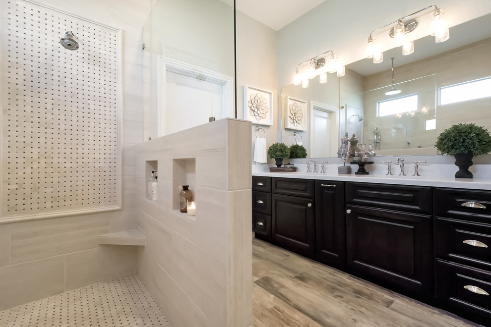 Inspiration for a mid-sized timeless master beige tile and porcelain tile porcelain tile and gray floor bathroom remodel in Phoenix with raised-panel cabinets, black cabinets, a one-piece toilet, gray walls, a drop-in sink and quartzite countertops
