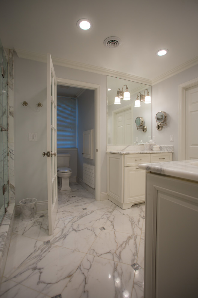 This is an example of a large classic ensuite bathroom in DC Metro with raised-panel cabinets, white cabinets, an alcove shower, a one-piece toilet, black and white tiles, ceramic tiles, white walls, marble flooring, a built-in sink and granite worktops.