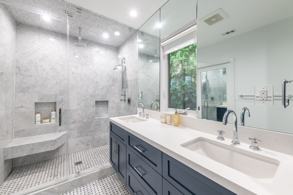 Inspiration for a large transitional master gray tile and porcelain tile marble floor, double-sink and gray floor bathroom remodel in Los Angeles with shaker cabinets, blue cabinets, a one-piece toilet, white walls, an undermount sink, quartz countertops, a hinged shower door, white countertops and a floating vanity