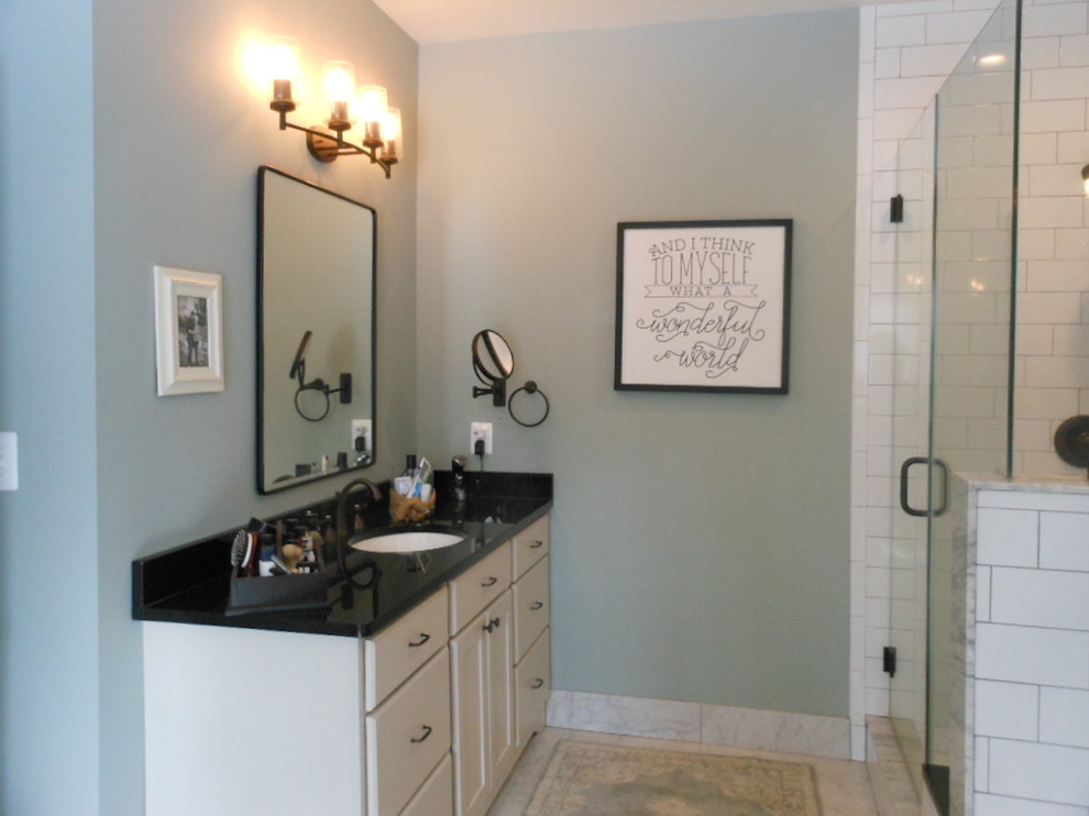Design ideas for a large country ensuite bathroom in DC Metro with flat-panel cabinets, white cabinets, white tiles, metro tiles, grey walls, porcelain flooring, a submerged sink, granite worktops, grey floors, a hinged door and black worktops.