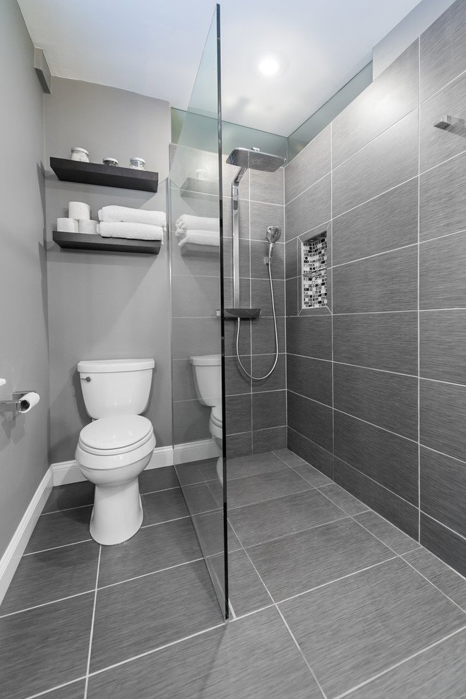 Photo of a small modern ensuite bathroom in Baltimore with a vessel sink, a built-in shower, a two-piece toilet, grey tiles, ceramic tiles, grey walls and ceramic flooring.