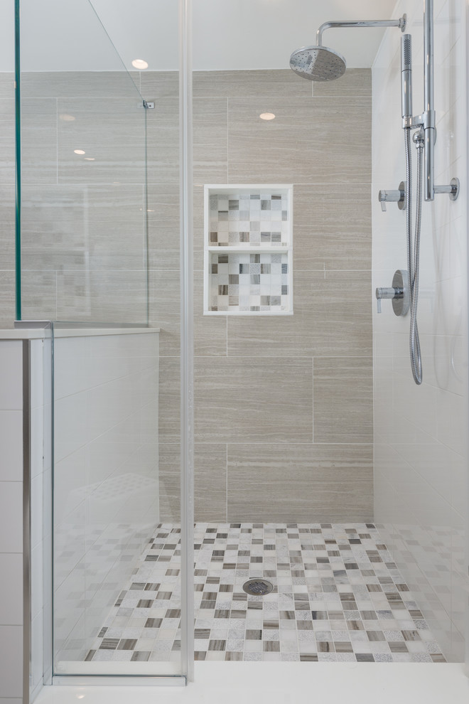 Example of a large trendy master brown tile and porcelain tile porcelain tile bathroom design in New York with flat-panel cabinets, medium tone wood cabinets, a one-piece toilet, gray walls, an undermount sink and marble countertops