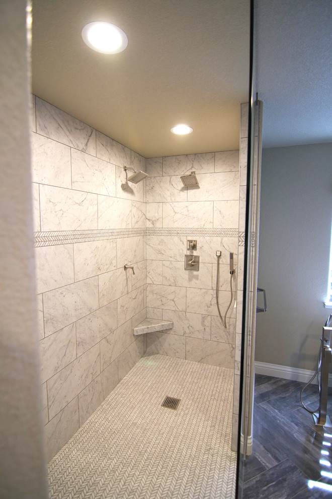 Large transitional master porcelain tile and brown floor bathroom photo in Sacramento with shaker cabinets, medium tone wood cabinets, a two-piece toilet, beige walls, a vessel sink, marble countertops and white countertops
