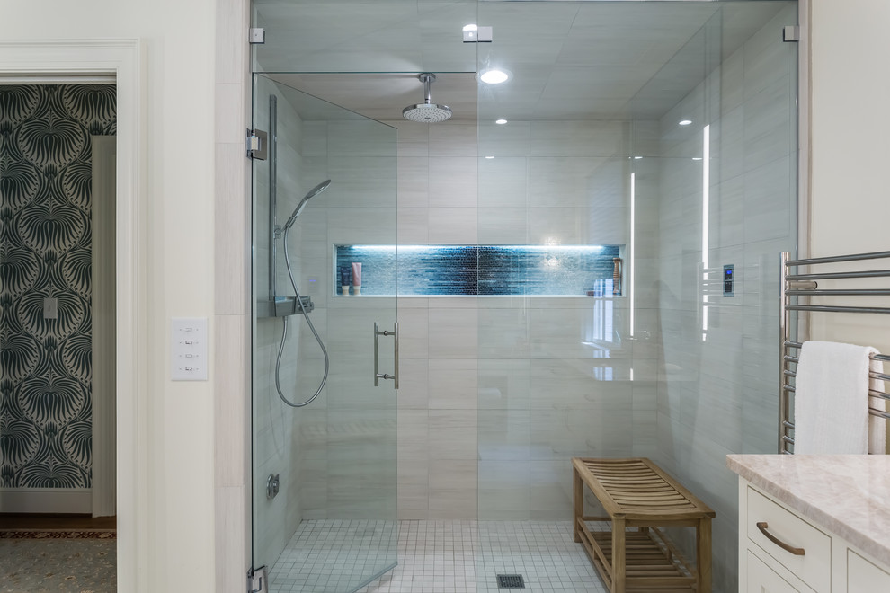 Walk-in shower - large transitional master white tile and porcelain tile porcelain tile and white floor walk-in shower idea in Raleigh with shaker cabinets, white cabinets, a wall-mount toilet, white walls, an undermount sink, quartzite countertops, a hinged shower door and beige countertops