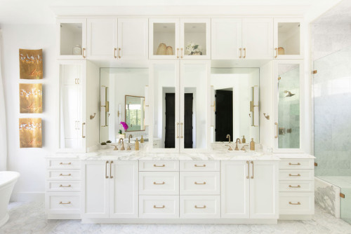 Bathroom Cabinets – white shaker double vanity with upper cabinets, mirrored panels, brass hardware, and marble countertop.