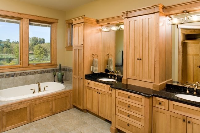Example of a large trendy master ceramic tile drop-in bathtub design in Chicago with recessed-panel cabinets, light wood cabinets, yellow walls and an undermount sink
