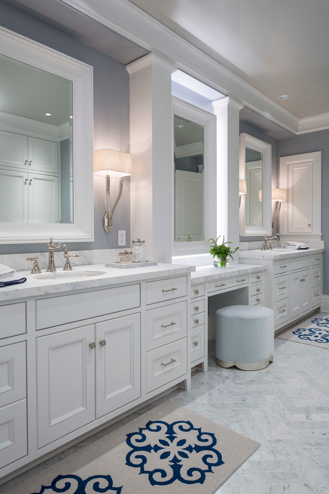 Example of a large transitional master marble floor and white floor freestanding bathtub design in Minneapolis with white cabinets, an undermount sink, marble countertops, recessed-panel cabinets, a two-piece toilet and white walls