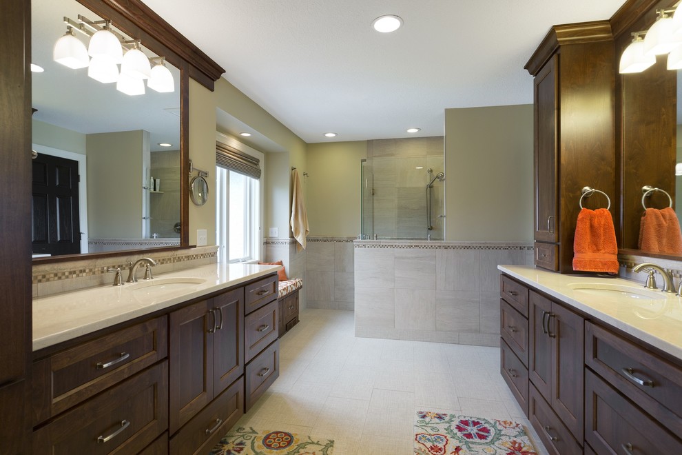 Inspiration for a large transitional master beige tile and ceramic tile ceramic tile walk-in shower remodel in Minneapolis with shaker cabinets, dark wood cabinets, a one-piece toilet, beige walls, an undermount sink and quartz countertops