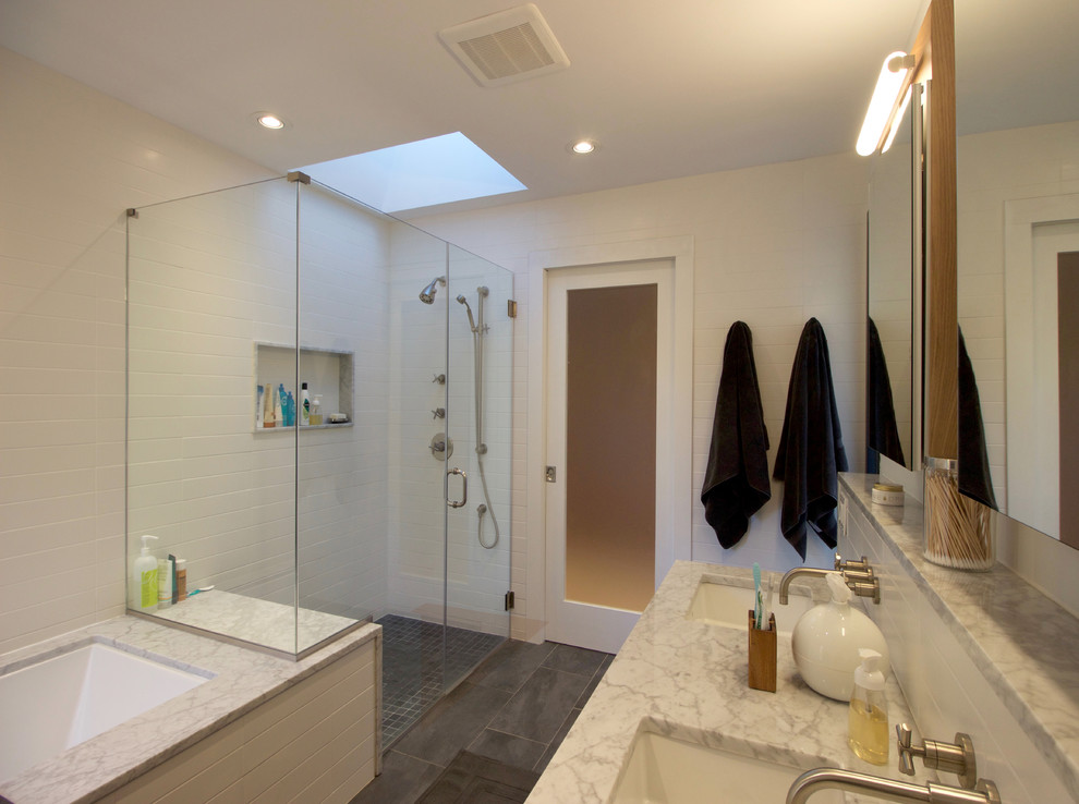 Mid-sized minimalist kids' white tile and ceramic tile ceramic tile and gray floor walk-in shower photo in Philadelphia with flat-panel cabinets, light wood cabinets, an undermount tub, a one-piece toilet, white walls, an integrated sink, a hinged shower door and marble countertops