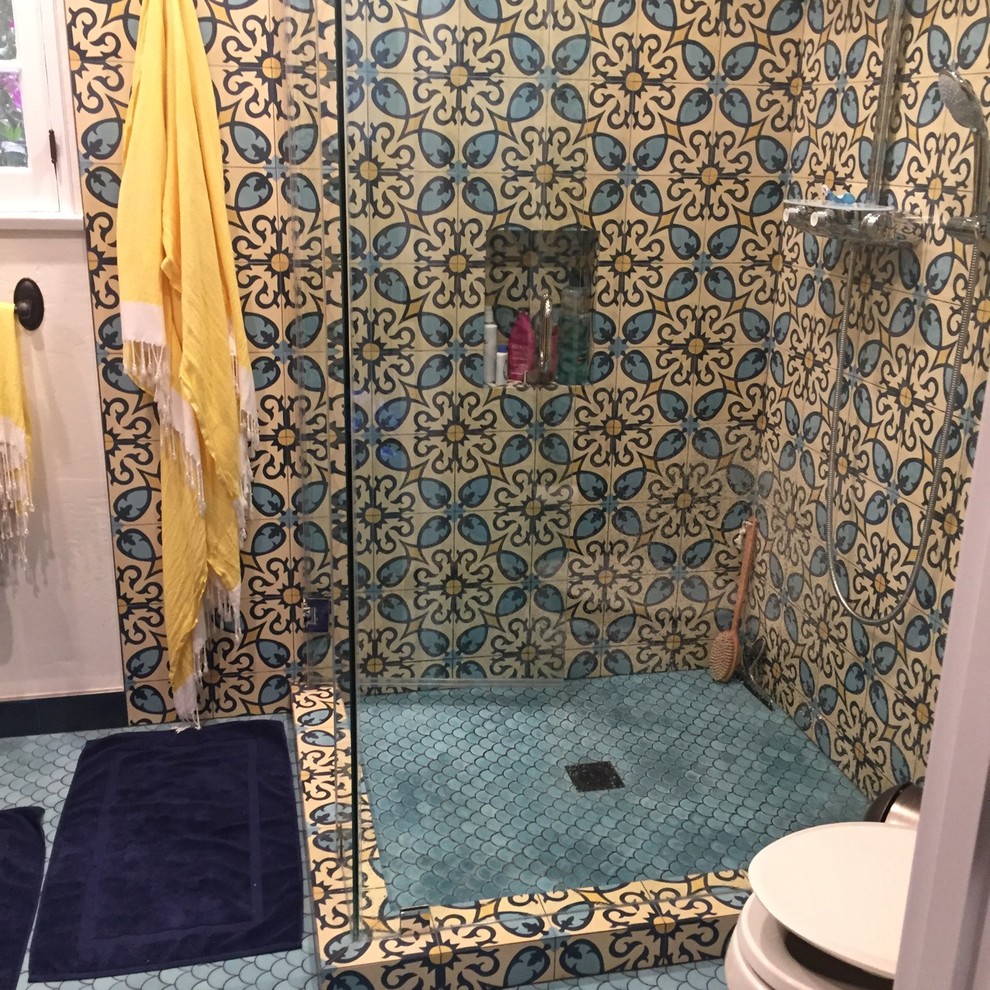 This is an example of a medium sized mediterranean shower room bathroom in Los Angeles with freestanding cabinets, brown cabinets, a corner shower, a one-piece toilet, blue tiles, cement tiles, blue walls, cement flooring, an integrated sink, tiled worktops, blue floors and a hinged door.