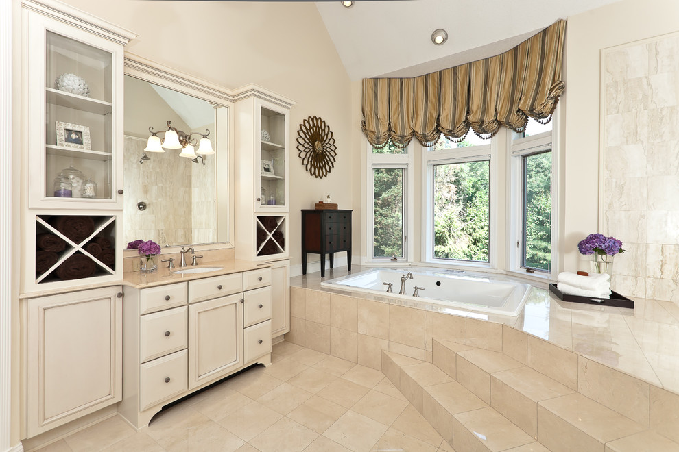 This is an example of a large traditional ensuite bathroom in Baltimore with a submerged sink, a built-in bath, beige tiles, recessed-panel cabinets, beige cabinets, a built-in shower, marble tiles, beige walls, marble flooring, marble worktops, beige floors and an open shower.