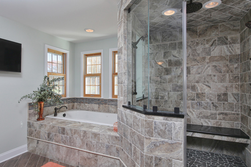 Large transitional master stone tile ceramic tile bathroom photo in Philadelphia with shaker cabinets, black cabinets, an undermount sink and solid surface countertops