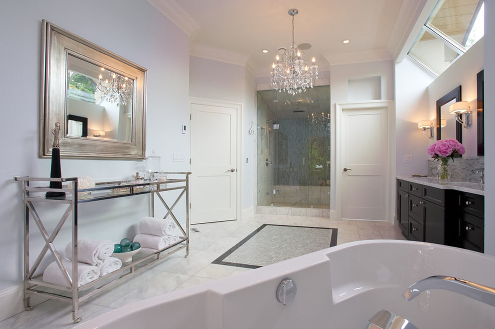 Diseño de cuarto de baño clásico renovado grande con lavabo bajoencimera, armarios con paneles empotrados, puertas de armario de madera en tonos medios, bañera exenta, ducha empotrada y baldosas y/o azulejos blancos