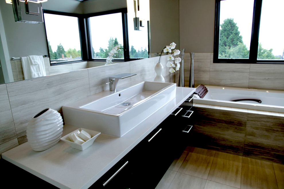 Inspiration for a mid-sized modern multicolored tile and stone slab drop-in bathtub remodel in Vancouver with a vessel sink, flat-panel cabinets, dark wood cabinets, quartz countertops and a one-piece toilet