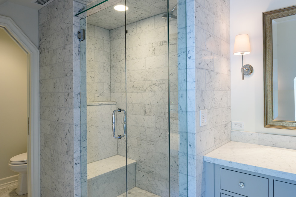 This is an example of a medium sized traditional ensuite bathroom in Seattle with flat-panel cabinets, grey cabinets, a claw-foot bath, an alcove shower, a two-piece toilet, grey tiles, stone tiles, white walls, marble flooring, a submerged sink and marble worktops.