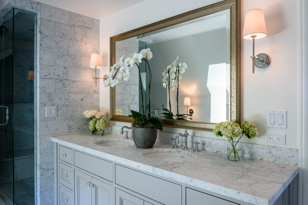Photo of a medium sized traditional ensuite bathroom in Seattle with flat-panel cabinets, grey cabinets, a claw-foot bath, an alcove shower, a two-piece toilet, grey tiles, stone tiles, white walls, marble flooring, a submerged sink and marble worktops.