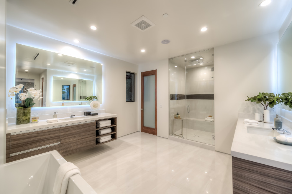 Example of a large minimalist master white tile and porcelain tile porcelain tile, white floor and single-sink bathroom design in Los Angeles with flat-panel cabinets, medium tone wood cabinets, a one-piece toilet, white walls, an undermount sink, quartz countertops, a hinged shower door, white countertops and a floating vanity