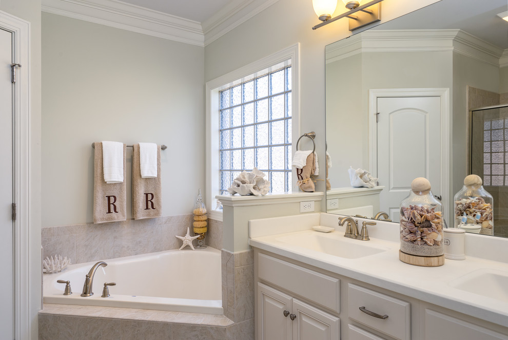 Example of a small beach style master beige tile and ceramic tile ceramic tile bathroom design in Wilmington with raised-panel cabinets, white cabinets, a two-piece toilet, beige walls, an integrated sink and quartz countertops