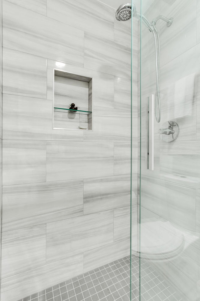 Inspiration for a medium sized modern ensuite bathroom in DC Metro with shaker cabinets, white cabinets, an alcove bath, an alcove shower, a one-piece toilet, grey tiles, ceramic tiles, grey walls, porcelain flooring, a submerged sink, engineered stone worktops, grey floors and a sliding door.