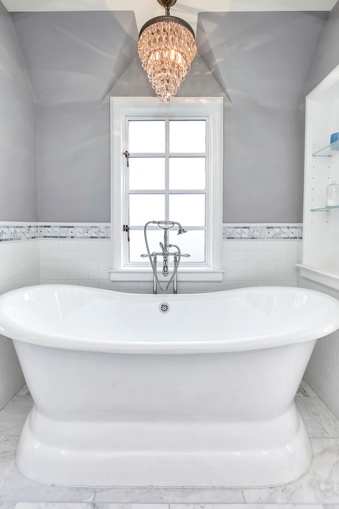 Design ideas for a medium sized traditional ensuite bathroom in Phoenix with shaker cabinets, white cabinets, a freestanding bath, an alcove shower, grey tiles, white tiles, metro tiles, grey walls, marble flooring, a submerged sink and engineered stone worktops.