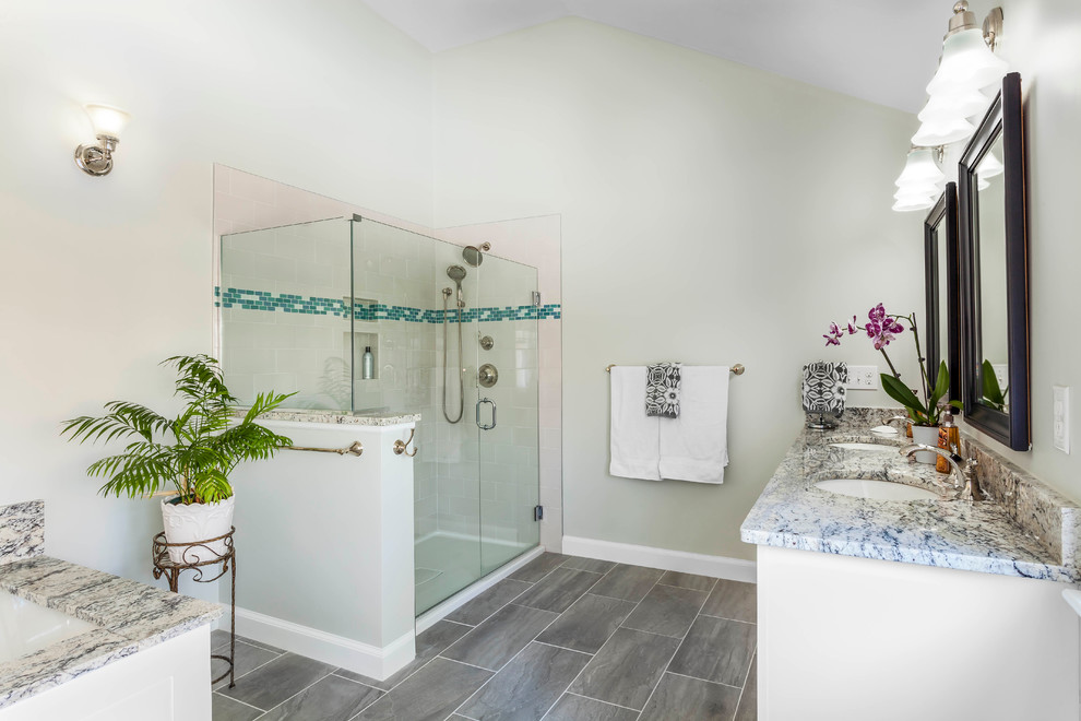 На фото: большая главная ванная комната в классическом стиле с фасадами с утопленной филенкой, белыми фасадами, угловой ванной, угловым душем, унитазом-моноблоком, керамической плиткой, зелеными стенами, полом из керамической плитки, врезной раковиной, столешницей из гранита, разноцветной плиткой и серым полом