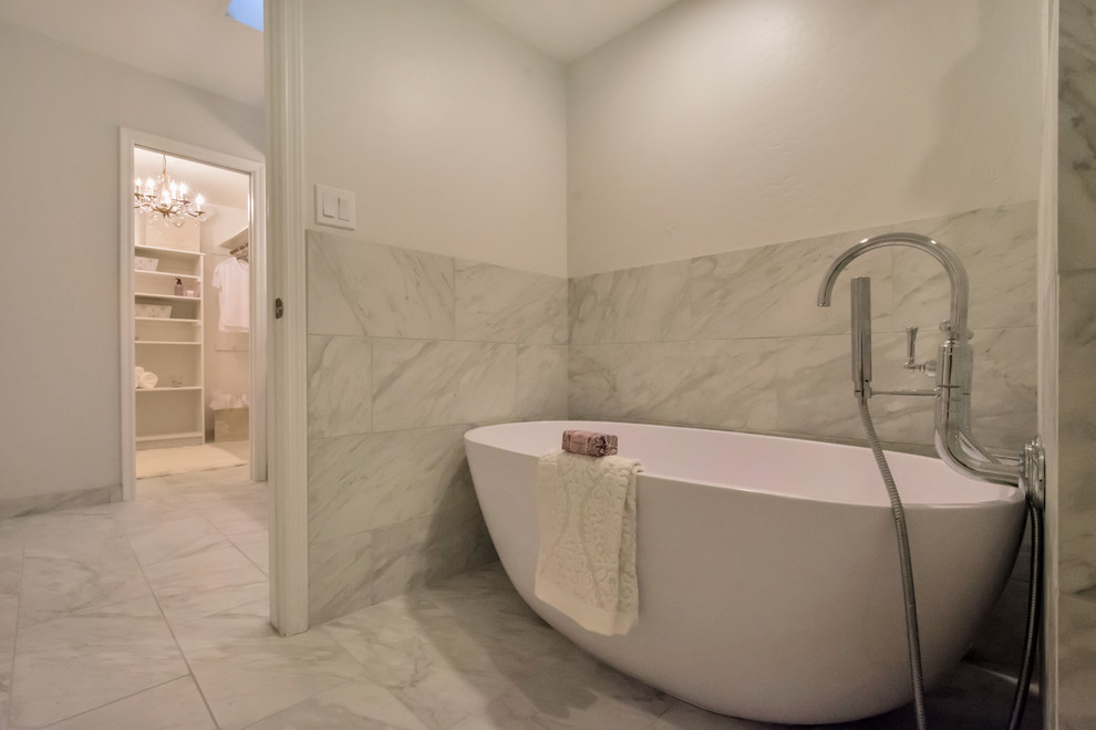 Large contemporary ensuite bathroom in Phoenix with raised-panel cabinets, white cabinets, a freestanding bath, an alcove shower, white tiles, metro tiles, grey walls, porcelain flooring, a built-in sink, granite worktops, grey floors and a hinged door.