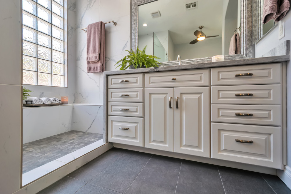 Inspiration for a mid-sized transitional master white tile and porcelain tile porcelain tile, gray floor and double-sink bathroom remodel in Phoenix with raised-panel cabinets, white cabinets, purple walls, an undermount sink, marble countertops, white countertops and a built-in vanity