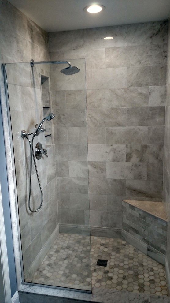 This is an example of a large mediterranean bathroom in Philadelphia with shaker cabinets, white cabinets, a freestanding bath, an alcove shower, a two-piece toilet, blue walls, ceramic flooring, a submerged sink, marble worktops, grey floors and an open shower.