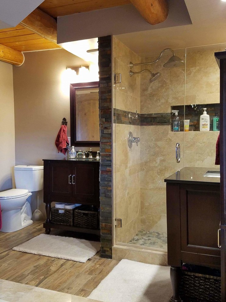 Design ideas for a large rustic ensuite bathroom in Denver with brown cabinets, a corner shower, beige tiles and light hardwood flooring.
