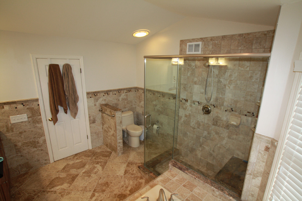Example of a mid-sized transitional master beige tile, brown tile and ceramic tile travertine floor alcove shower design in New York with a one-piece toilet, beige walls, a drop-in sink and tile countertops