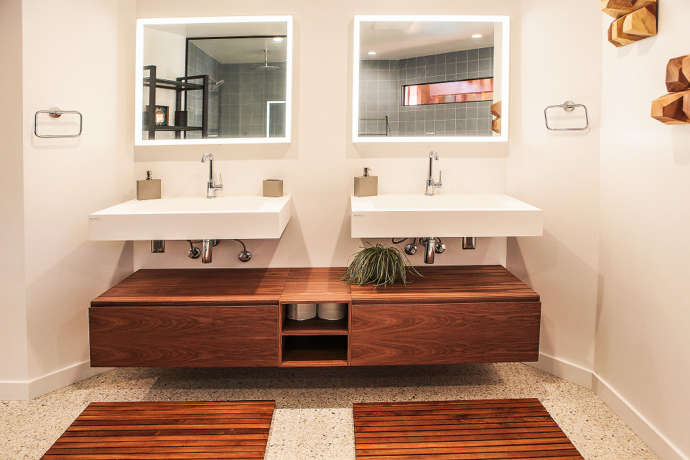 Medium sized modern ensuite bathroom in Los Angeles with open cabinets, brown cabinets, a freestanding bath, a built-in shower, a one-piece toilet, blue tiles, metro tiles, white walls, terrazzo flooring, a wall-mounted sink, yellow floors and an open shower.