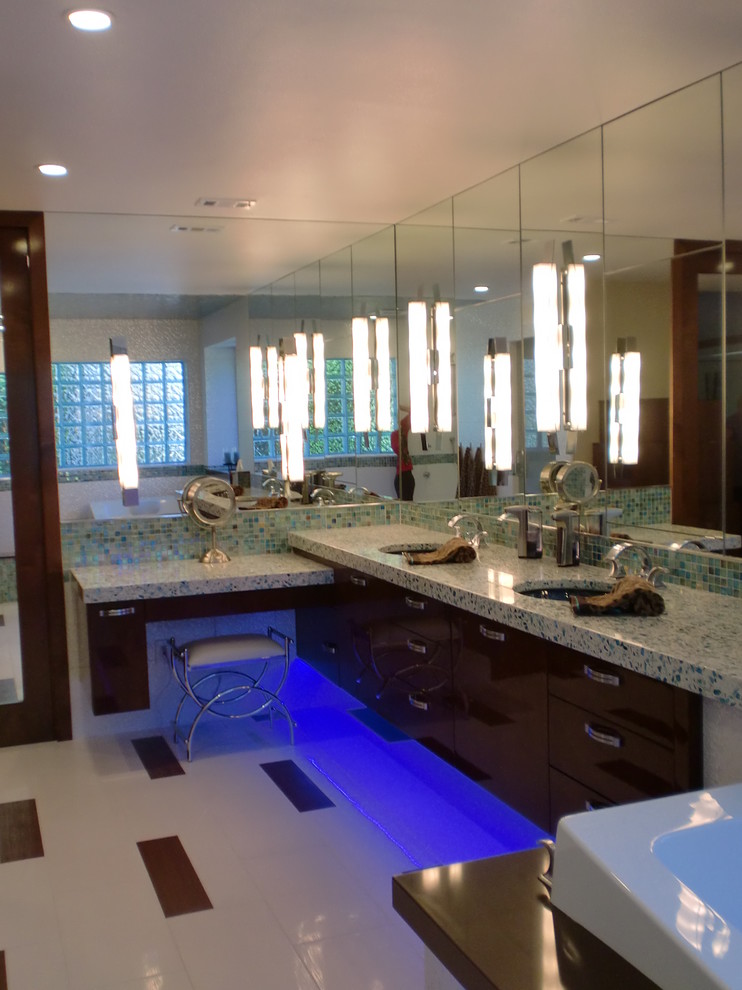 This is an example of a large modern ensuite bathroom in Orange County with dark wood cabinets, a hot tub, blue tiles, multi-coloured tiles, white walls, porcelain flooring, a submerged sink, granite worktops, flat-panel cabinets, an alcove shower and glass sheet walls.