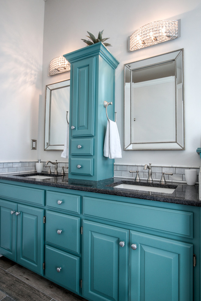 Example of a transitional master gray tile and marble tile brown floor double shower design in Kansas City with turquoise cabinets, white walls, an undermount sink and granite countertops