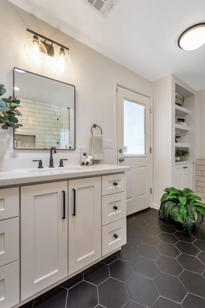 Example of a mid-sized transitional master white tile and subway tile porcelain tile, black floor and double-sink bathroom design in Phoenix with shaker cabinets, white cabinets, an undermount sink, quartz countertops, a hinged shower door, white countertops, a niche and a built-in vanity