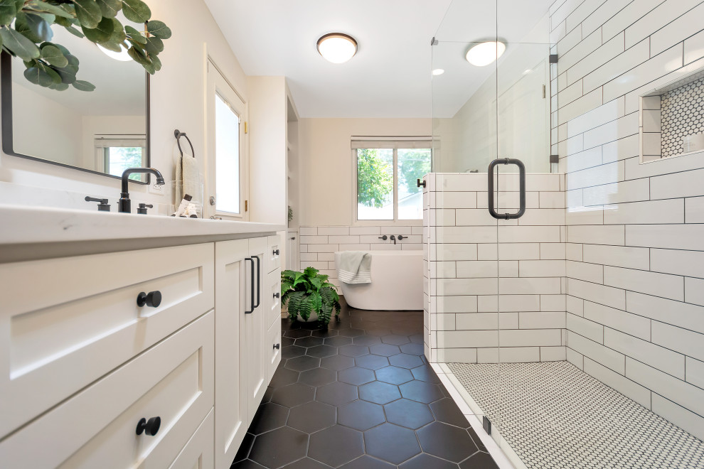 Inspiration for a medium sized traditional ensuite bathroom in Phoenix with shaker cabinets, white cabinets, a freestanding bath, a built-in shower, white tiles, metro tiles, porcelain flooring, a submerged sink, engineered stone worktops, black floors, a hinged door, white worktops, a wall niche, double sinks and a built in vanity unit.