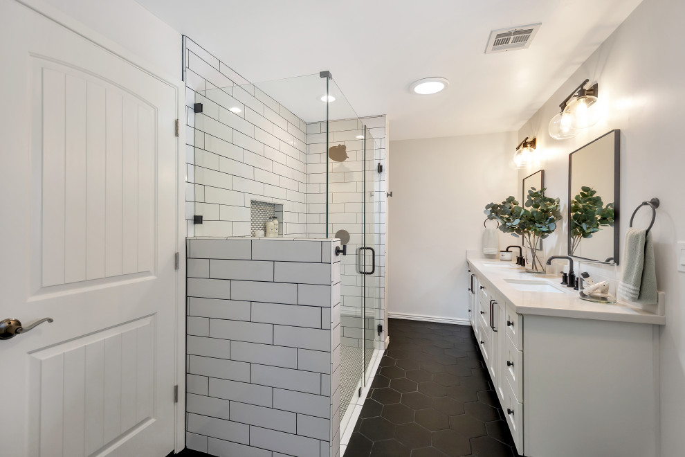 Bathroom - mid-sized transitional master white tile and subway tile porcelain tile, black floor and double-sink bathroom idea in Phoenix with shaker cabinets, white cabinets, an undermount sink, quartz countertops, a hinged shower door, white countertops, a niche and a built-in vanity