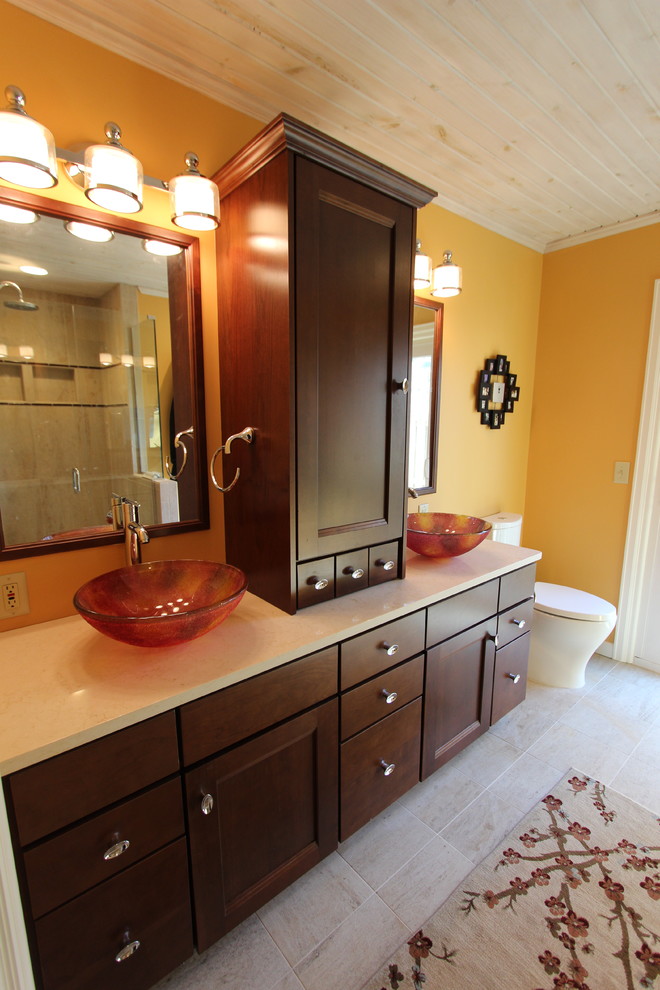 Mid-sized transitional master beige tile and glass tile ceramic tile corner shower photo in Cleveland with a vessel sink, flat-panel cabinets, dark wood cabinets, quartz countertops, a two-piece toilet and yellow walls