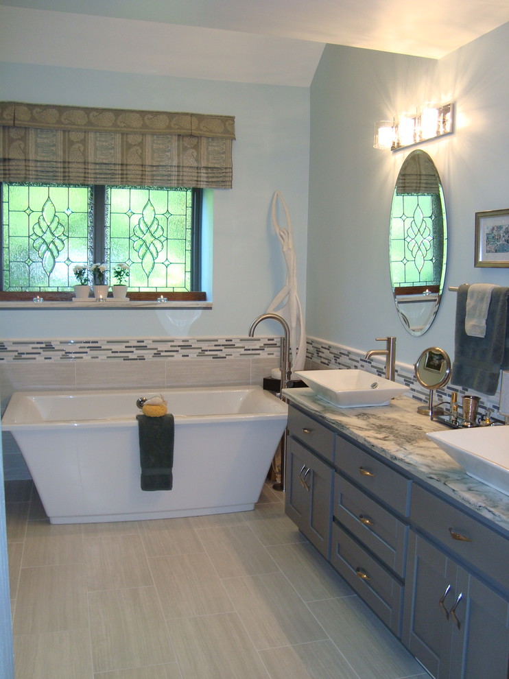 Inspiration for a large coastal master gray tile and porcelain tile porcelain tile bathroom remodel in Chicago with a vessel sink, shaker cabinets, gray cabinets, marble countertops, a two-piece toilet and blue walls