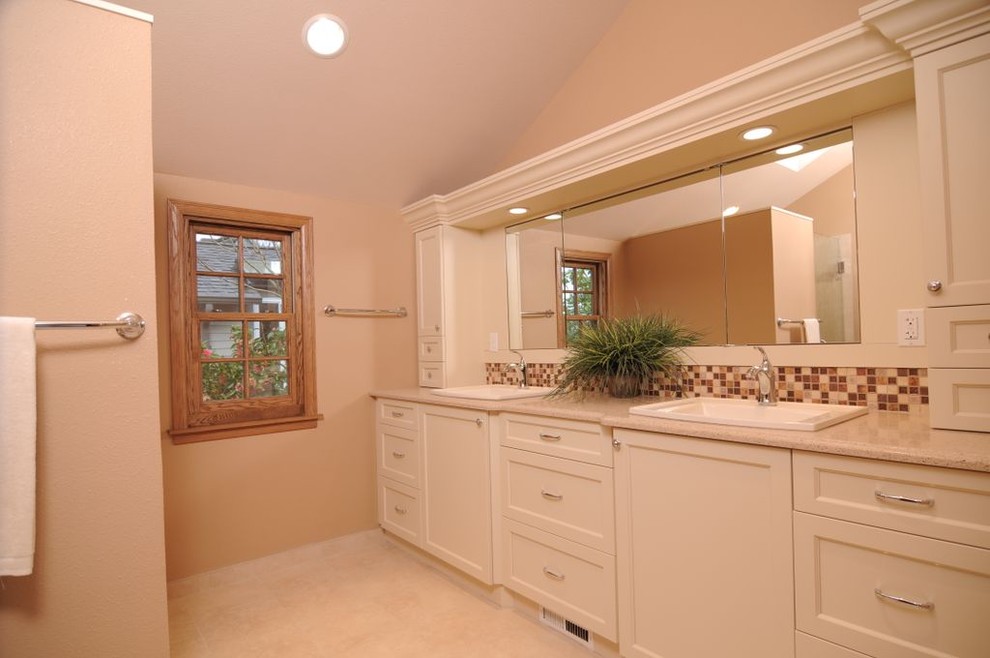 This is an example of a classic ensuite bathroom in Seattle with white cabinets and beige walls.
