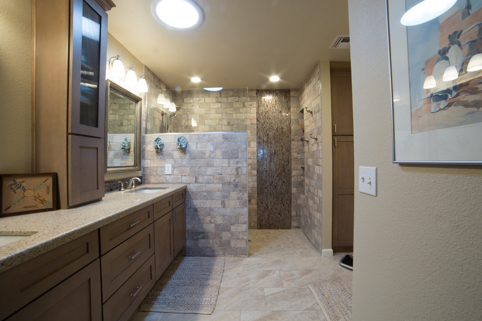Example of a large mountain style master multicolored tile and porcelain tile porcelain tile and beige floor bathroom design in Phoenix with recessed-panel cabinets, medium tone wood cabinets, beige walls, an undermount sink, quartzite countertops and beige countertops