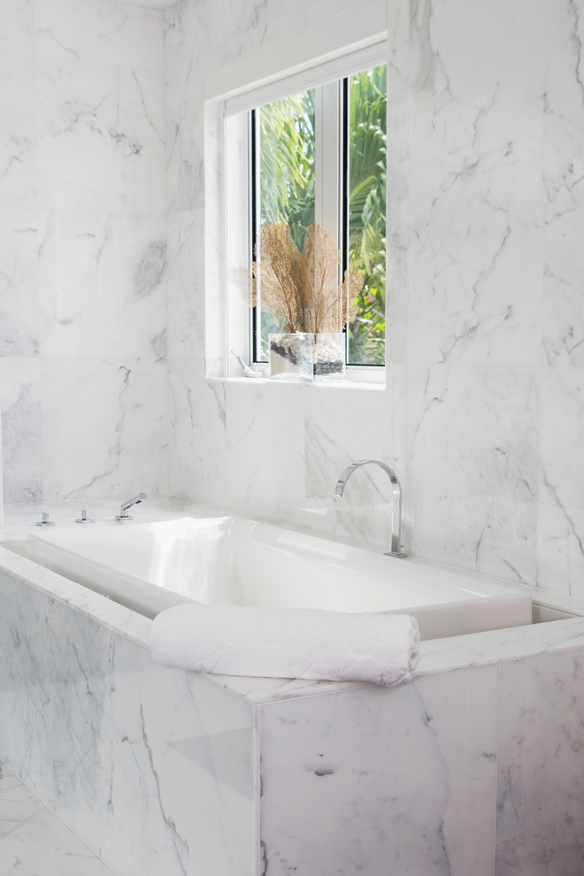 Example of a mid-sized trendy master white tile and marble tile marble floor and white floor bathroom design in San Francisco with flat-panel cabinets, brown cabinets, white walls, a drop-in sink, marble countertops and a hinged shower door
