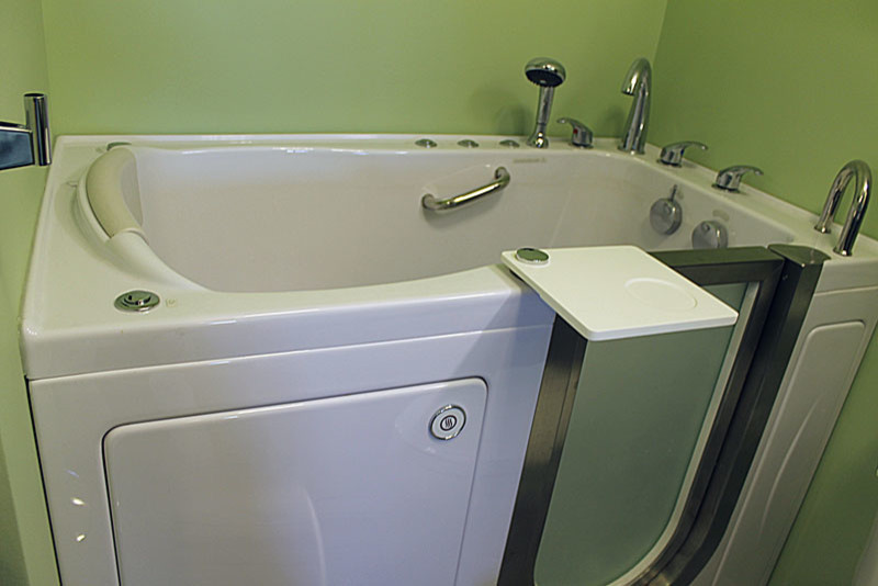 This is an example of an ensuite bathroom in Chicago with a two-piece toilet, white tiles, ceramic tiles, green walls, ceramic flooring, an integrated sink and granite worktops.