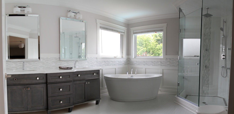 Example of a large transitional master white tile and mosaic tile porcelain tile bathroom design in Toronto with an undermount sink, furniture-like cabinets, gray cabinets, quartz countertops, a two-piece toilet and gray walls