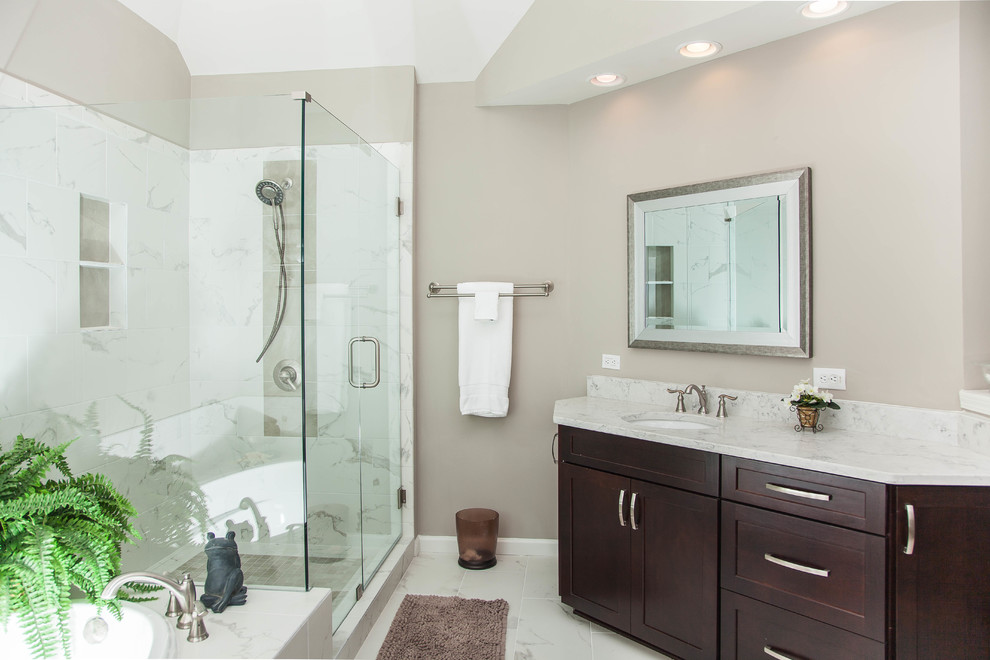 Bathroom - large contemporary master white tile and porcelain tile porcelain tile and white floor bathroom idea in Atlanta with flat-panel cabinets, dark wood cabinets, a one-piece toilet, beige walls, an undermount sink, quartz countertops and a hinged shower door