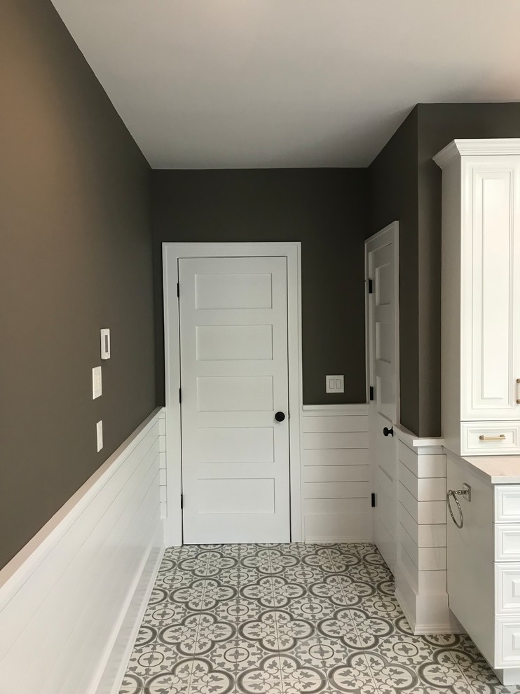 Mid-sized trendy master gray tile and porcelain tile ceramic tile and multicolored floor bathroom photo in New York with raised-panel cabinets, white cabinets, brown walls, an undermount sink, a hinged shower door and beige countertops