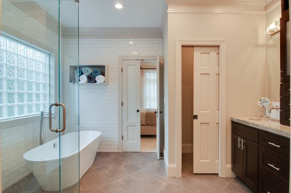 Inspiration for a mid-sized modern master white tile and ceramic tile ceramic tile bathroom remodel in Nashville with an integrated sink, shaker cabinets, dark wood cabinets, concrete countertops, a one-piece toilet and gray walls